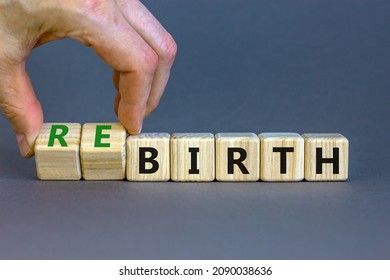 Birth or rebirth symbol. Businessman turns wooden cubes and changes the word birth to rebirth. Beautiful grey table grey background, copy space. Business, birth or rebirth concept.