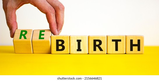 Birth or rebirth symbol. Businessman turns wooden cubes and changes the word birth to rebirth. Beautiful yellow table white background, copy space. Business, birth or rebirth concept.