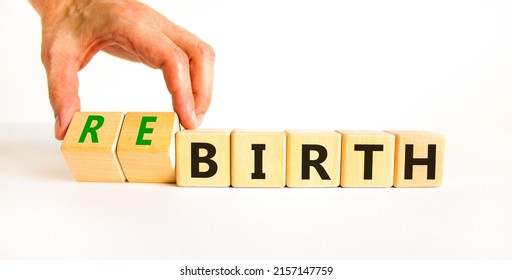 Birth or rebirth symbol. Businessman turns wooden cubes and changes the word birth to rebirth. Beautiful white table white background, copy space. Business, birth or rebirth concept.
