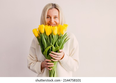 Birthday, 40 years old, happy woman with bouquet of flowers and balloons isolated on white - Powered by Shutterstock