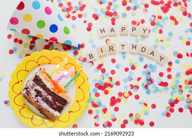 Birthday Background With Tasty Cake On A Plate, Paper Party Hat, Colorful Confetti And Wooden Sign Letters