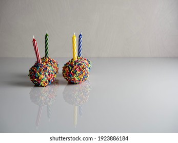 Birthday Cake Balls, Truffle Dessert, Decorated With White Coating And Colorful Sprinkles, Delicious For A Celebration On A White Surface With A High Gloss Reflection.