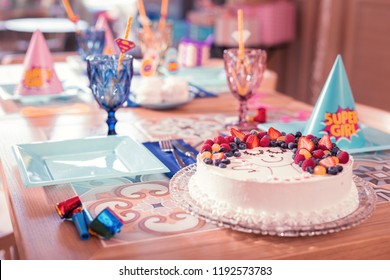 Birthday cake. Beautiful view of the party table with tasty cake decorated with various berries