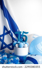 Birthday cake with candles in the form of the number 75 In blue and white colors, Concept of the Israeli holiday Independence Day - Shutterstock ID 2290380355