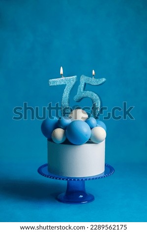 Birthday cake with candles in the form of the number 75 In blue and white colors, Concept of the Israeli holiday Independence Day