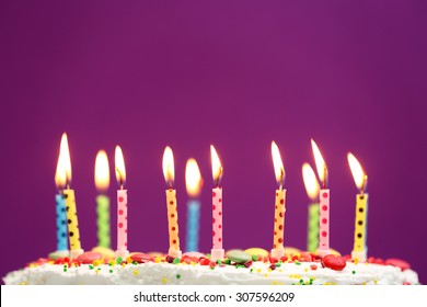 Birthday Cake With Candles On Purple Background