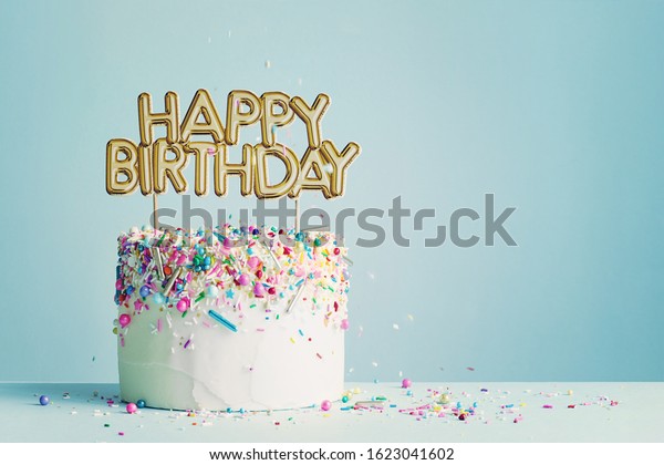 Birthday cake with\
gold happy birthday\
banner
