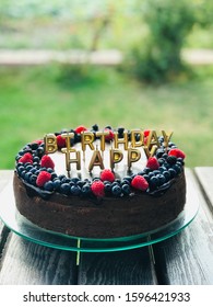 birthday cake with golden happy birthday banner. - Shutterstock ID 1596421933