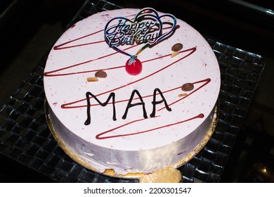 Birthday Cake For Indian Mother Called Maa. Beautiful Cheese Cake With Cheery At Top. Dark Background