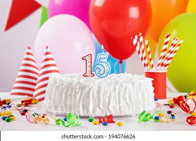 Birthday Cake On Colorful Balloon Background With Other Birthday Decoration. Focus is on cake.