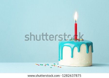 Birthday cake with one red candle and drip frosting