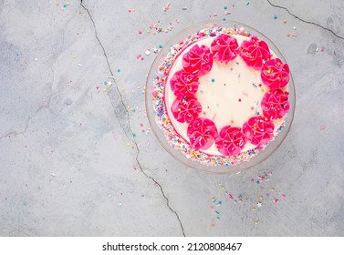 Birthday Cake With Pink Buttercream Icing And Sprinkles