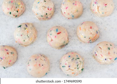 Birthday Cake Sprinkled Edible Cookie Dough Balls On White Parchment Paper.