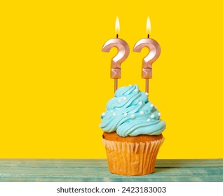 Birthday Cake With Two Question Mark Candles - On Yellow Background.