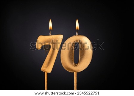 Birthday candle number 70 - Birthday celebration on black background