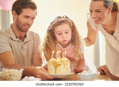 Birthday, Candles And Family Celebration With Cake, Parents And Girl For A Happy Family Event. Happiness, Love And Smile Of A Mother, Father And Young Daughter Together Blowing A Candle In A Home