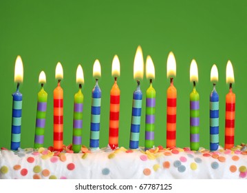 Birthday candles on green background