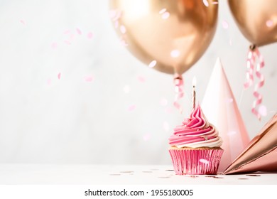 Birthday Celebration With Pink Birthday Cupcake, Party Hats And Rose Gold Balloons