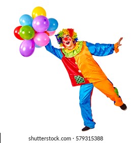 Birthday child clown with balloons bunch on isolated. Events organizer man is standing on one leg on white background.
