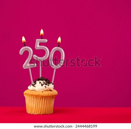 Birthday cupcake with candle number 250 - Rhodamine Red foamy background