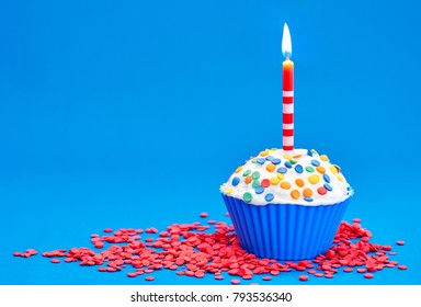 Birthday Cupcake With Candles On Blue Background