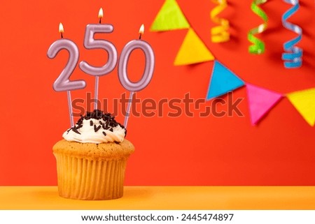 Birthday cupcake with number 250 candle - Sparkling orange background with bunting