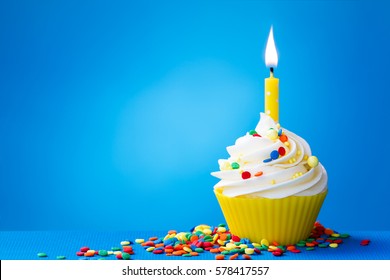 Birthday cupcake with a single yellow candle