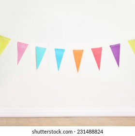 Birthday Decoration Flags On A Plain White Wall Shot With Tilt And Shift Lens