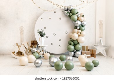 Birthday decorations - gifts, toys, balloons, garland and number for little baby party event on a white wall background. - Shutterstock ID 1927565051