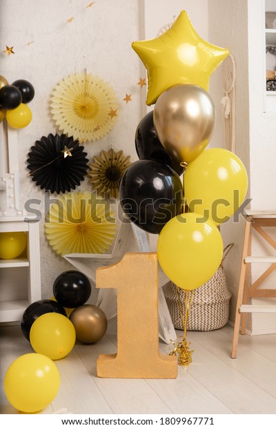 Birthday\
decorations - gifts, toys, balloons, garland and figure for little\
baby party on a white wall\
background.