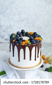 Birthday Drip Cake With Chocolate And Blueberries And Physalis