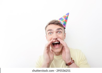 Birthday Kid. Close Up Portrait Of Young-looking Happy Guy Wearing Birthday Paper Hat And Screaming. 