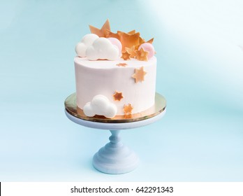 Birthday layered cake with macaron clouds and chocolate golden stars
