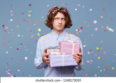 Birthday Man Accepts Congratulations, Holds Gifts From Guests, Looks Puzzled Away, Tries To Recall Something, Little Confused