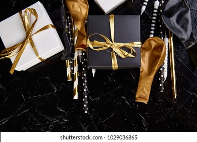 Birthday Or Party Accessories Set With Gift Boxes, Balloon, Candles In Gold, Black And White Color. Flat Lay, Top View