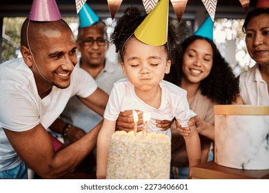 Birthday, party and cake for boy with parents and grandparents together for celebrating, bond and fun. Joy, event and child blowing candles with family at table, happy and excited for celebration - Powered by Shutterstock