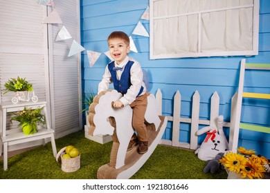 Birthday Party For Cute Child. Fun, Joy, Celebration And Holiday. Surprised Kid Looking At Camera On Blue Background. Little Baby Boy Celebrating His Birthday. Trendy Children Clothes, Party Concept