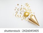 Birthday party festive background with golden decoration from carnival hat, gift box, balloons, confetti, candy and streamers top view.