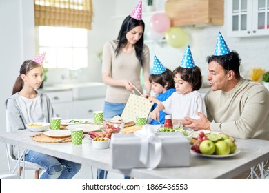 Birthday Party. Happy Hispanic Family Having Dinner While Celebrating Birthday Together At Home