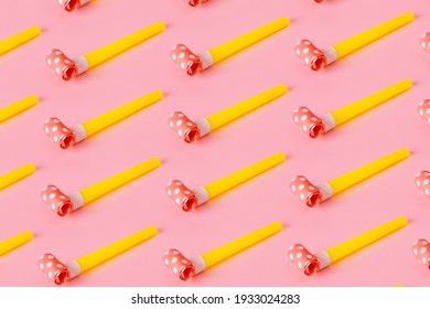 Birthday party whistles on pink background, colorful celebration pattern with party blower horns, minimal party concept. - Shutterstock ID 1933024283