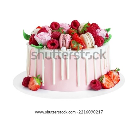 Birthday sweet cake with berries, macaron and floral decor isolated on a white background. Beautiful pink cake decorated with macarons, raspberries, strawberries and sugar rose flowers. 