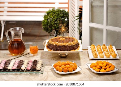 Birthday Table Setting With Cake, A Sparkler, Candies, Soda And Brazilian Snacks