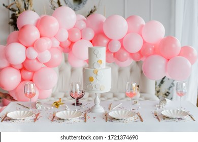 Birthday Or Wedding Table Setting In White Colors With Cocktails In Glasses. Baby Shower Or Girl Party. Selective Focus. Balloon Garland