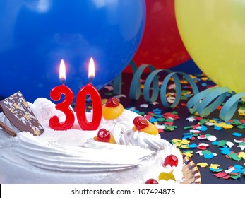 Birthday-anniversary cake with red candle showing Nr. 30