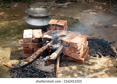 Biryani Cooking In A Village Party On A Temporary Brick Made Oven. Outdoor Cooking For Lots Of People In Large Aluminum Pan In Wooden Fire.