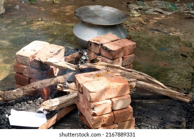 Biryani Cooking In A Village Party On A Temporary Brick Made Oven. Outdoor Cooking For Lots Of People In Large Aluminum Pan In Wooden Fire.