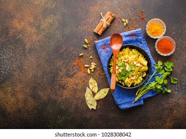 Biryani rice, traditional Indian dish. Biryani spicy rice, chicken, nuts. Indian rice bowl, spices, herbs, rustic stone background. Top view. Space for text. Asian style biryani rice. Indian dinner - Powered by Shutterstock