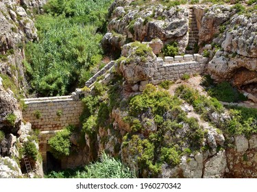 BIRZEBBUGA, MALTA - Jul 10, 2015: A defensive stop wall built by the British military in Wied Znuber valley, Malta, to stop sea invasion  Equipped with musketry loophole and parapet 