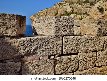 BIRZEBBUGA, MALTA - Jul 10, 2015: A defensive stop wall built by the British military in Wied Znuber valley, Malta, to stop sea invasion  Equipped with musketry loophole and parapet 