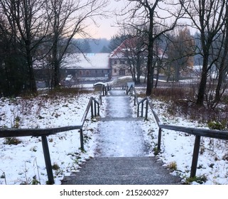 Bischofsheim, Germany - November 9, 2019: Stairs covered in snow and ice leading down the mountain at Kreuzberg monastery on a fall day in Germany.